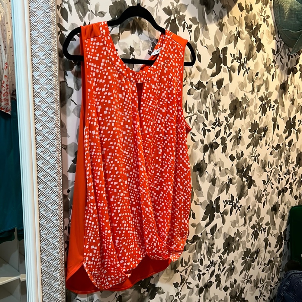 Sleeveless top, relaxed fit with bow detail at back neck.